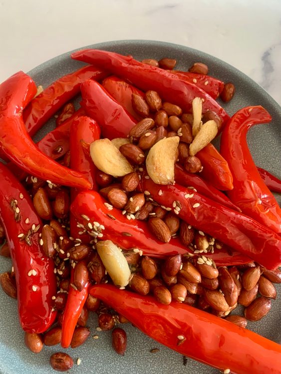 Step 1.2: Add the red chillies, garlic cloves, and raw peanuts