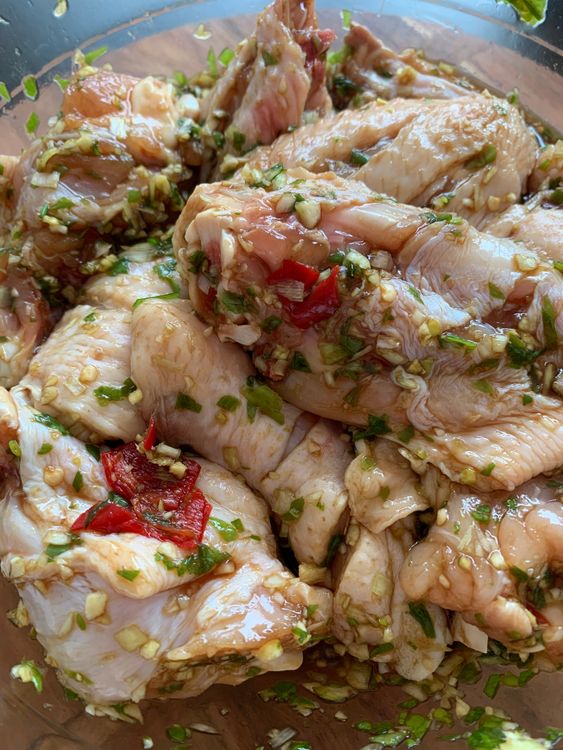 Step 1.5: Marinate the chicken wings in a large mixing bowl with the chopped ingredients, fish sauce, soy sauce, and sugar