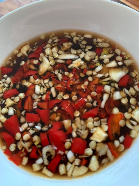 Step 2.1: In a bowl, mix the cooled sugar syrup with fish sauce, lime juice, finely chopped Thai chillies, and crushed garlic