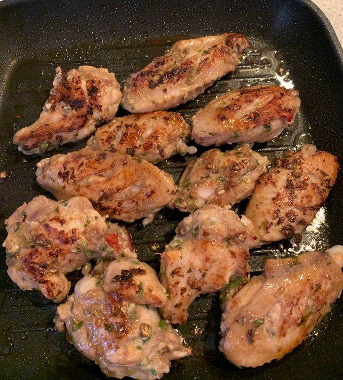 Step 1.5: Place the marinated chicken wings on the grill pan, cooking for about 8-10 minutes per side until they're cooked through and develop a nice char