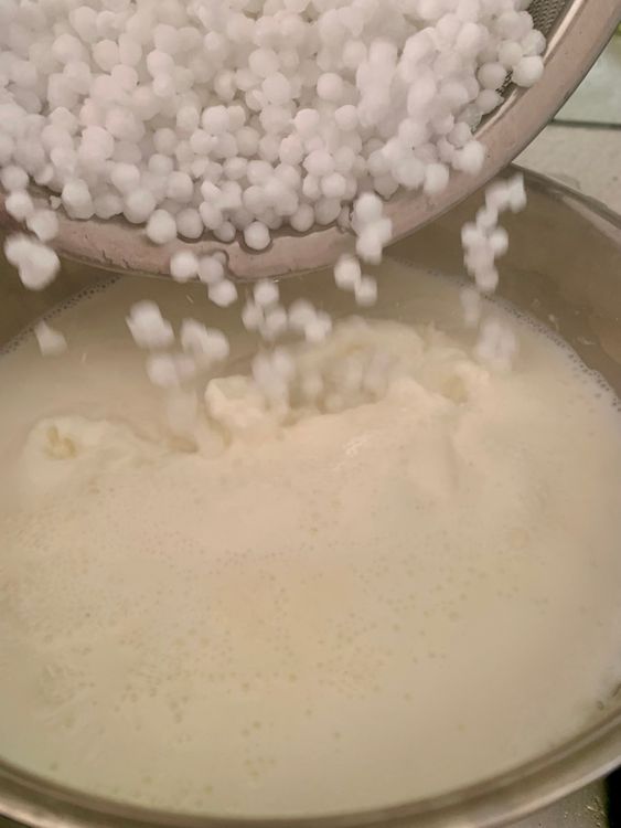 Step 3.1: In a heavy-bottomed pan, bring the milk to a gentle boil