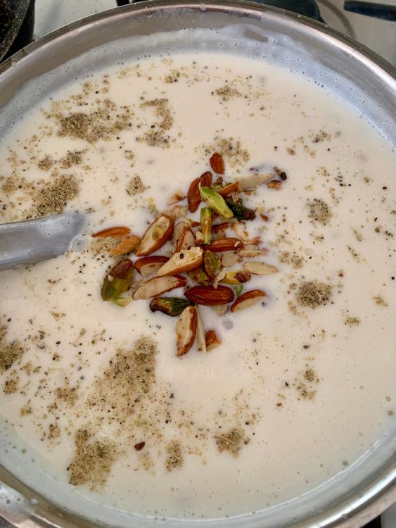 Step 5.2: Add sugar, cardamom powder, and 3 tablespoons of the roasted nuts (reserve 1 tablespoon for garnish), along with saffron strands if using