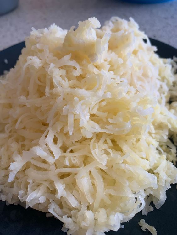 Step 1.1: In a mixing bowl, grate or mash the boiled potatoes