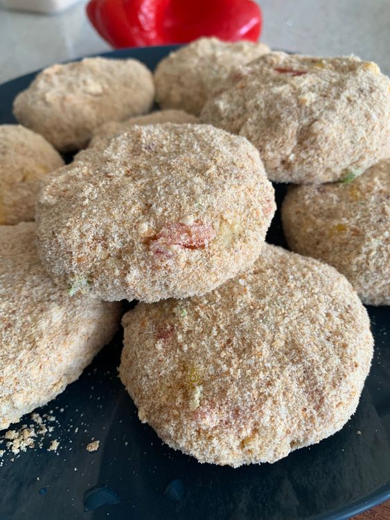 Step 2.3: Dip each cutlet in the prepared cornflour slurry, then coat it evenly with bread crumbs