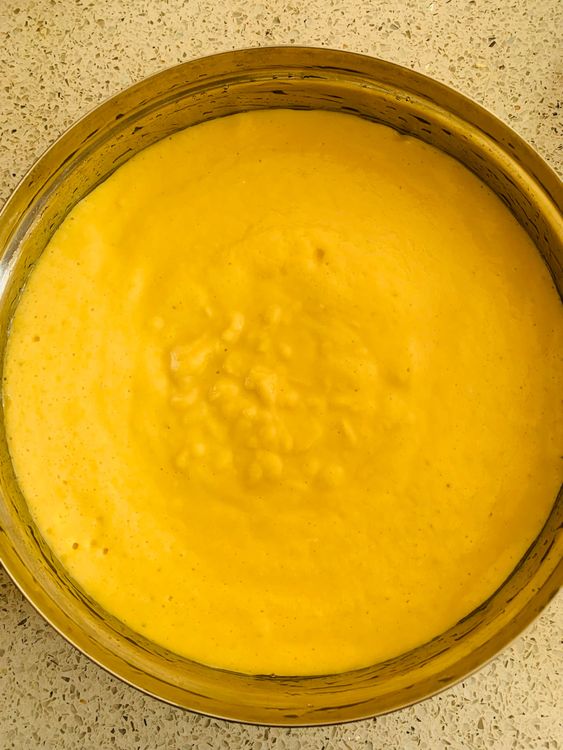 Step 3.1: Immediately pour the batter into the greased tin and place it in the pan or steamer