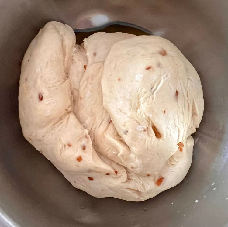 Step 1.2: Take a bowl, oil it with olive oil, then place the dough in it