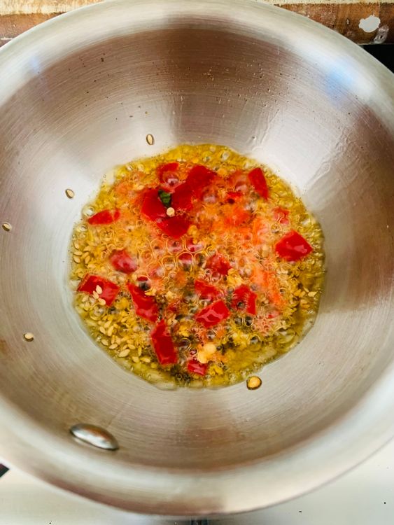 Step 4.1: Add sesame seeds, hing, and chopped chillies