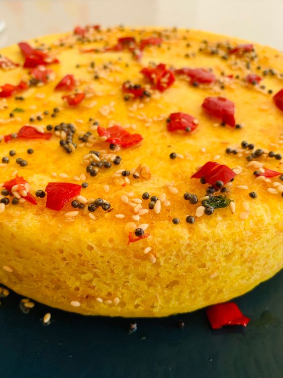 Step 4.1: Pour the tempering evenly over the steamed dhokla
