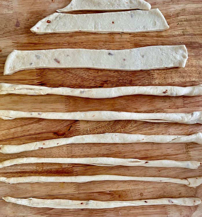 Step 1.1: Taking one strand, use both of your hands to roll the dough into a thin, circular strand
