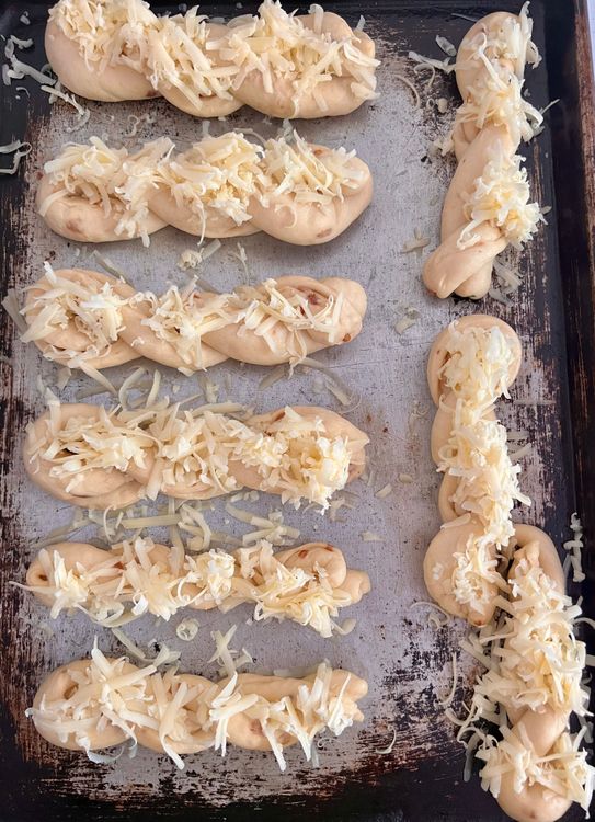 Step 1.1: When the twists are puffy and just the way you like them, add the cheddar cheese on top