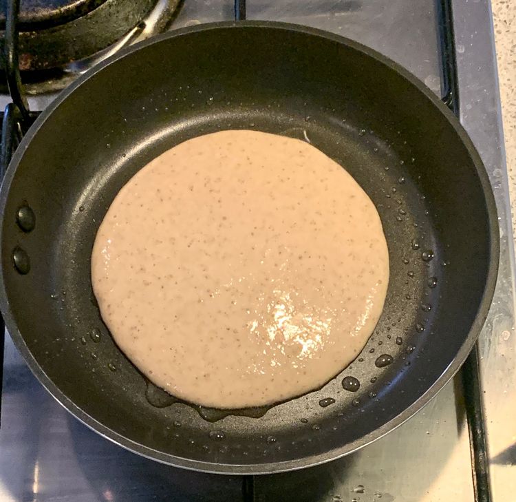 Step 1.1: Using a 1/2 cup measure or a spoon ladle, pour the batter onto the skillet and slightly press down with the ladle to flatten it to a pancake shape