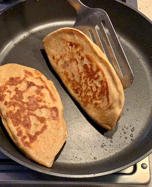 Step 2.1: Apply oil to both sides of the paratha and cook until golden brown from all sides