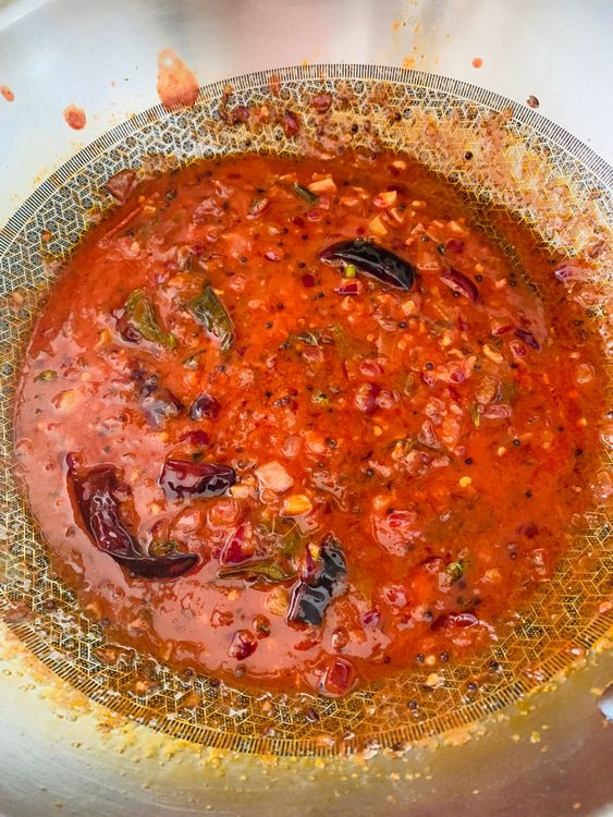 Step 2.1: Mix in the Kashmiri chilli powder, followed by tomato purée and a splash of water