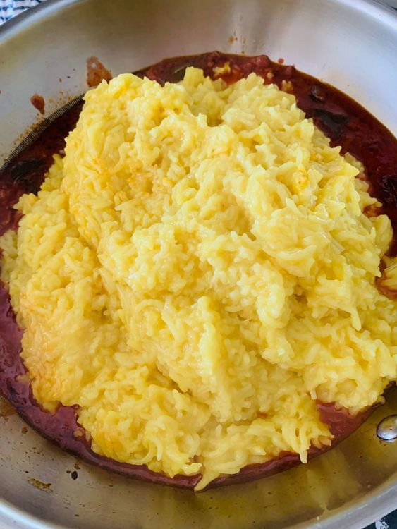 Step 3.1: Add the cooked rice-dal mixture to the kadhai and mix well with the masala