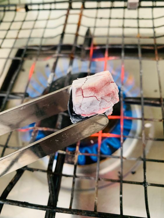 Step 2.1: Heat a piece of coal until red hot, place it on the foil, drizzle with a teaspoon of oil, and immediately cover the bowl with a tight lid
