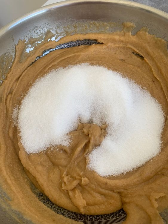 Step 1.1: Add sugar and stir continuously until it combines, and the ghee starts to separate, leaving the pan's edges