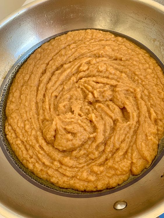 Step 1.2: Add sugar and stir continuously until it combines, and the ghee starts to separate, leaving the pan's edges