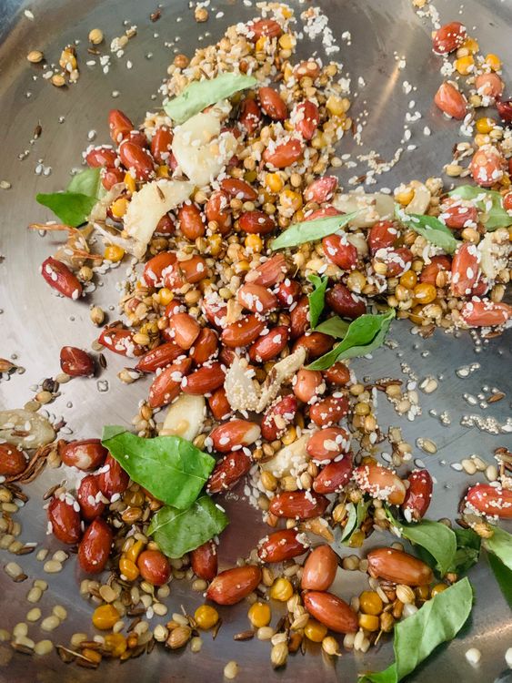 Step 1.2: Add sesame seeds, poppy seeds, and a few curry leaves