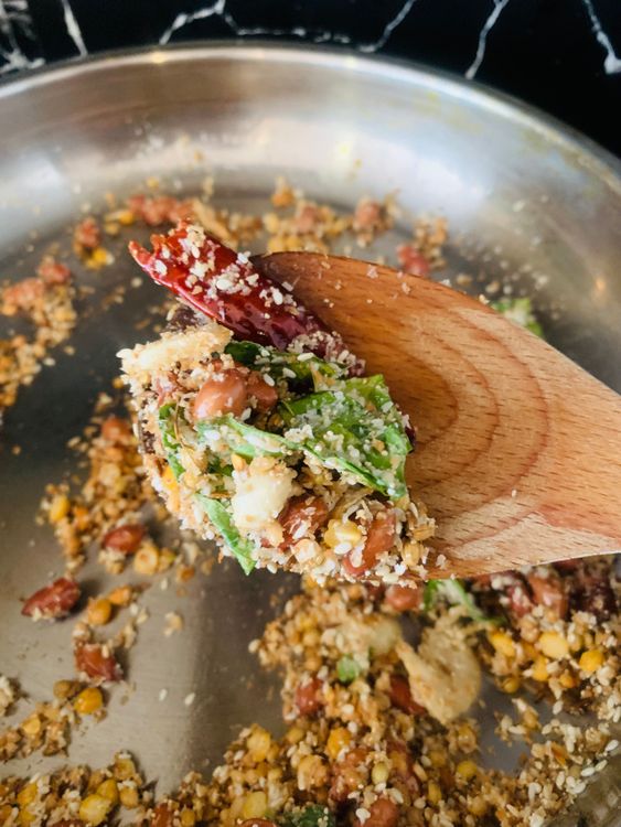 Step 1.2: Add the dry red chillies and desiccated coconut and continue roasting until the coconut turns lightly golden and fragrant