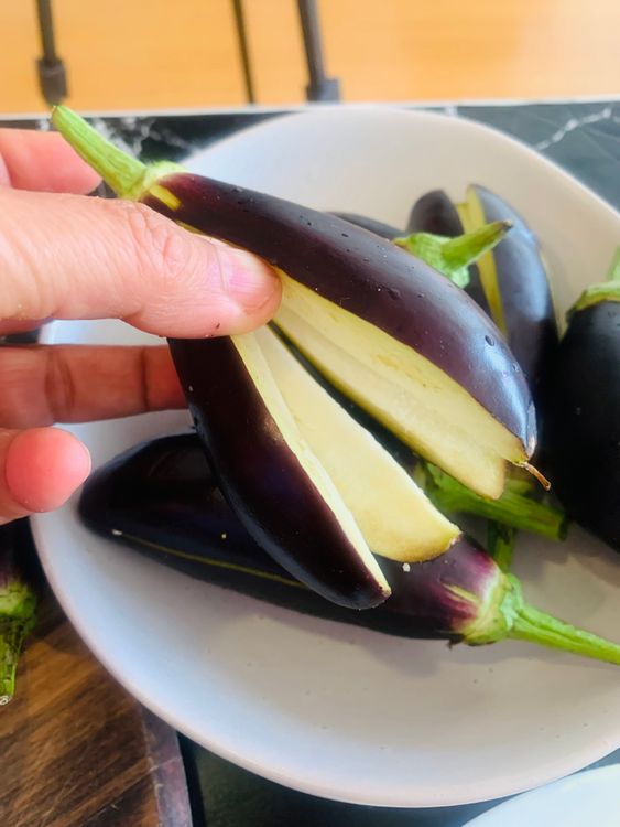 Step 2.1: Wash and pat dry the brinjals