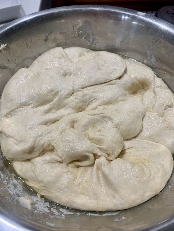 Step 1.1: Cover the dough in a greased bowl with a clean kitchen towel