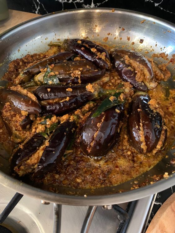 Step 3.1: Mix the masala gently with the brinjals and continue cooking until the eggplants are fully tender and their skin looks wilted and well roasted