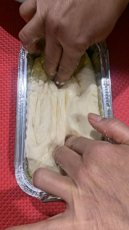 Step 1.1: Place the dough in the foil tray and roll it in the olive oil