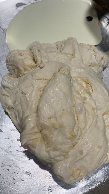 Step 1.1: Add the chopped garlic to the dough and gently mix it with a dough cutter