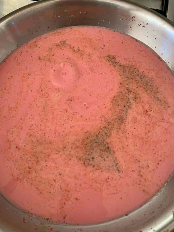 Step 5.1: Pour in the milk and sprinkle the cardamom powder
