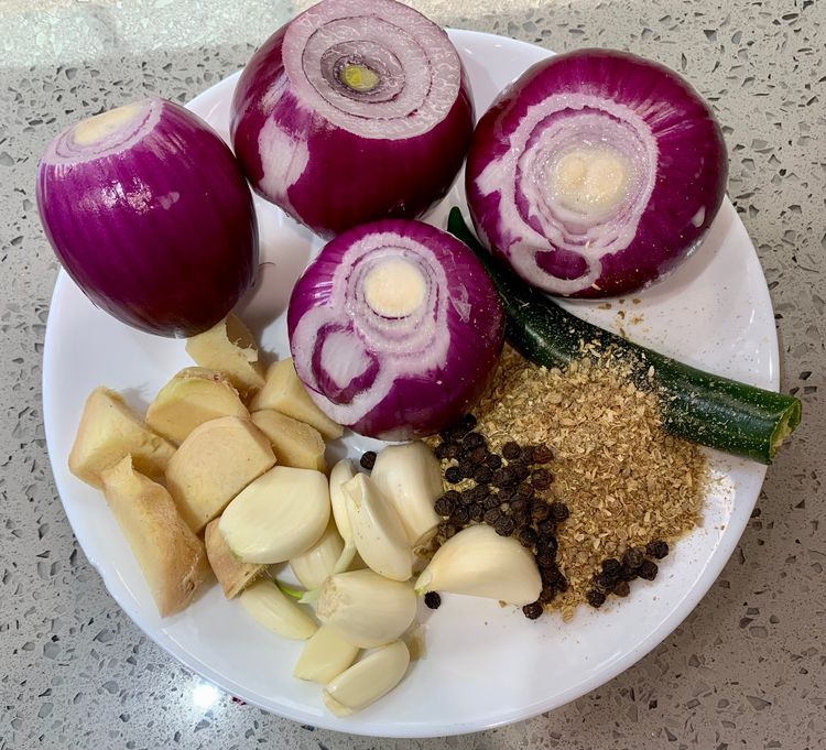 Step 1.1: In a grinder jar, finely blend onion, green chillies, garlic cloves, ginger, black peppercorns, and coriander seeds into a smooth paste