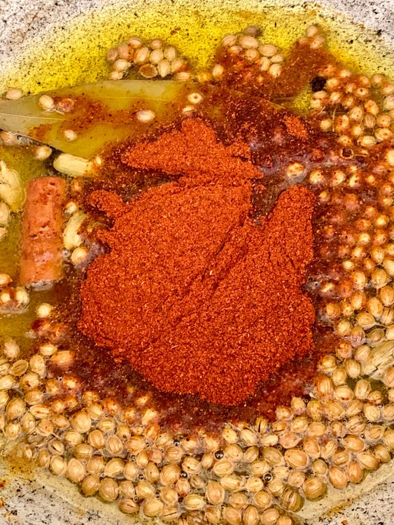 Step 3.1: Lower the heat and quickly stir in the Kashmiri chilli powder — be careful not to burn it