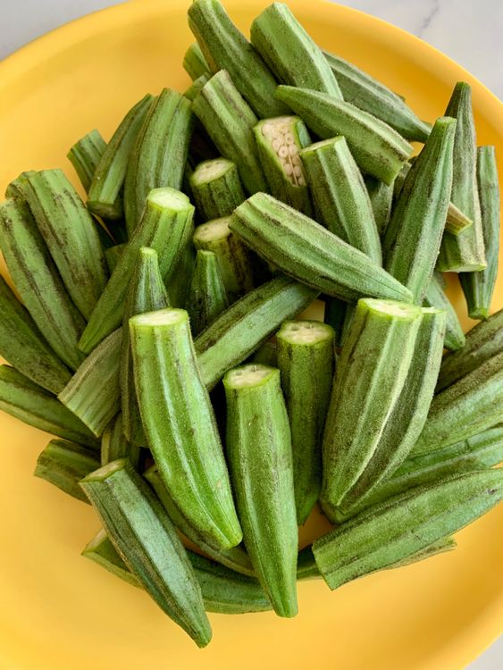 Step 1.1: Trim both ends, then make a lengthwise slit in each bhindi—keeping them whole—so they can be stuffed