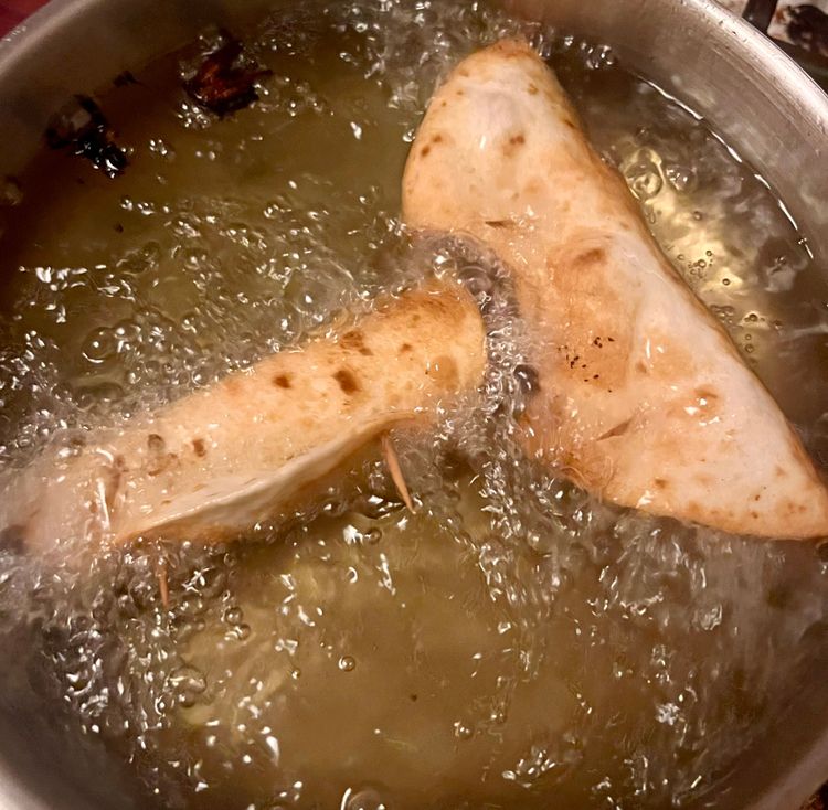 Step 1.1: Once the oil is hot enough, carefully place one of the taquitos in the oil using tongs