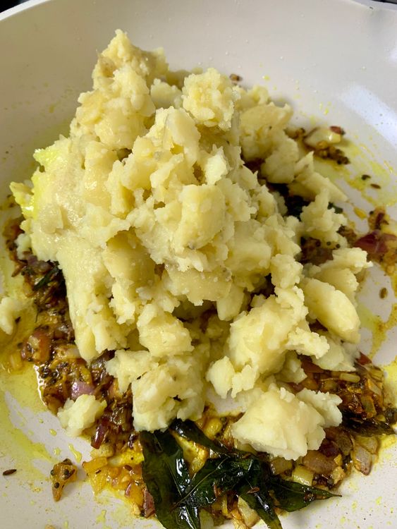 Step 1.2: Mix in turmeric and salt, then add the mashed potatoes