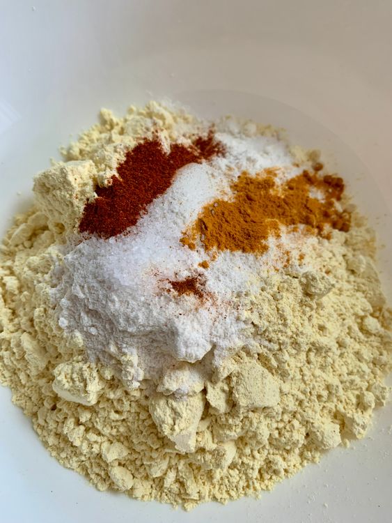 Step 2.1: In a mixing bowl, whisk together besan, cornflour/rice flour, turmeric, salt, and red chilli powder (if using)
