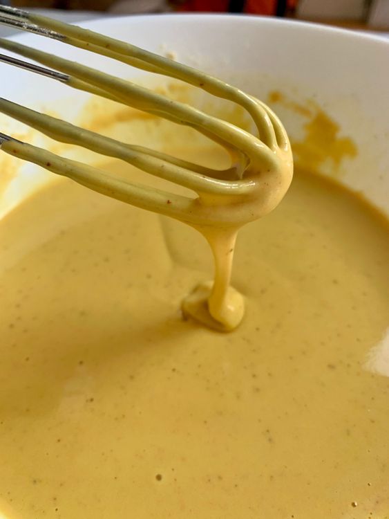 Step 2.1: Gradually add water to form a smooth, medium-thick batter with a pourable consistency