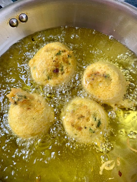Step 3.2: Dip each potato ball into the batter, ensuring it's evenly coated, and gently slide it into the hot oil