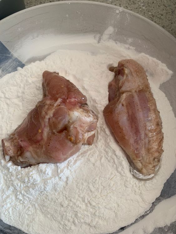 Step 3.1: Dredge each marinated wing in the flour mix, shaking off excess
