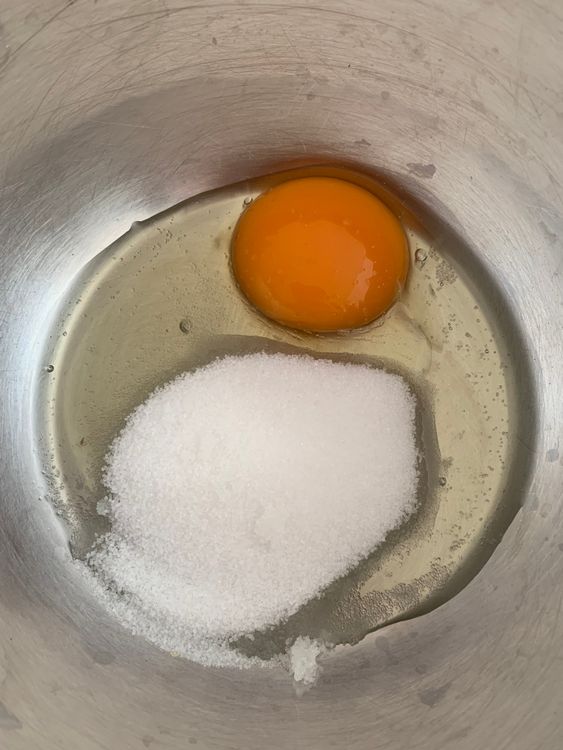 Step 1.1: In a large mixing bowl, whisk the egg and sugar together until the sugar dissolves