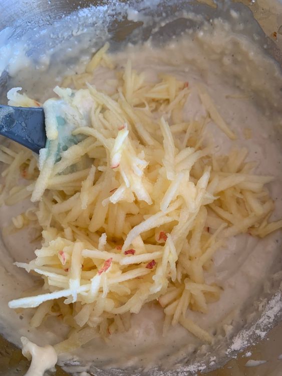 Step 2.1: Fold in the grated apple, then gradually mix in the remaining flour