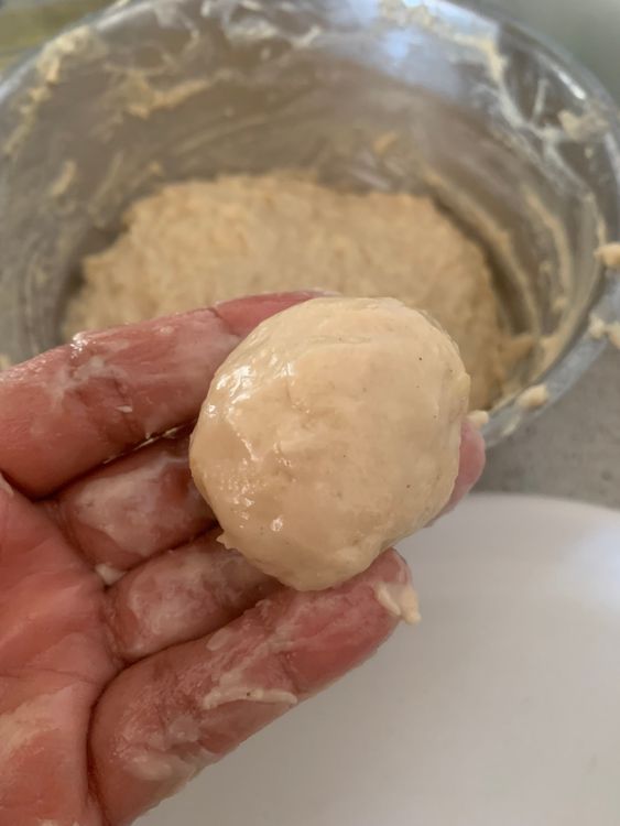 Step 3.1: Lightly grease your hands, take small portions of dough, and roll into small lemon-sized balls