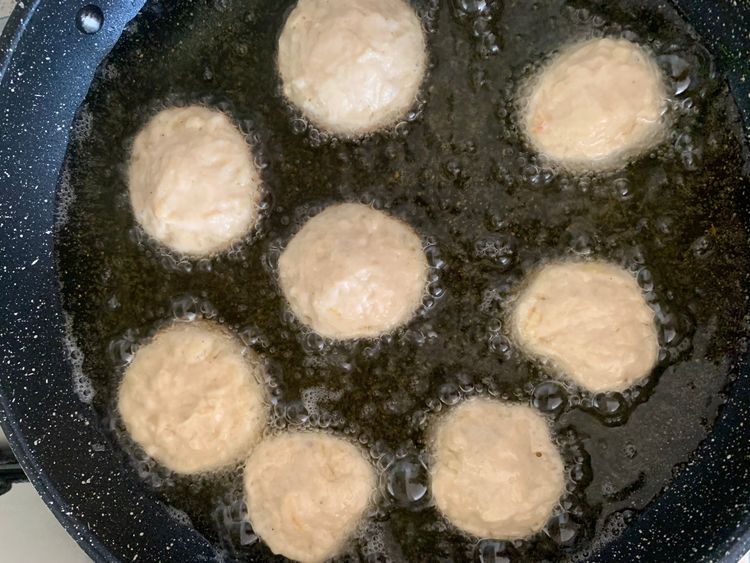 Step 3.1: Carefully drop them into the hot oil, in batches, avoiding overcrowding
