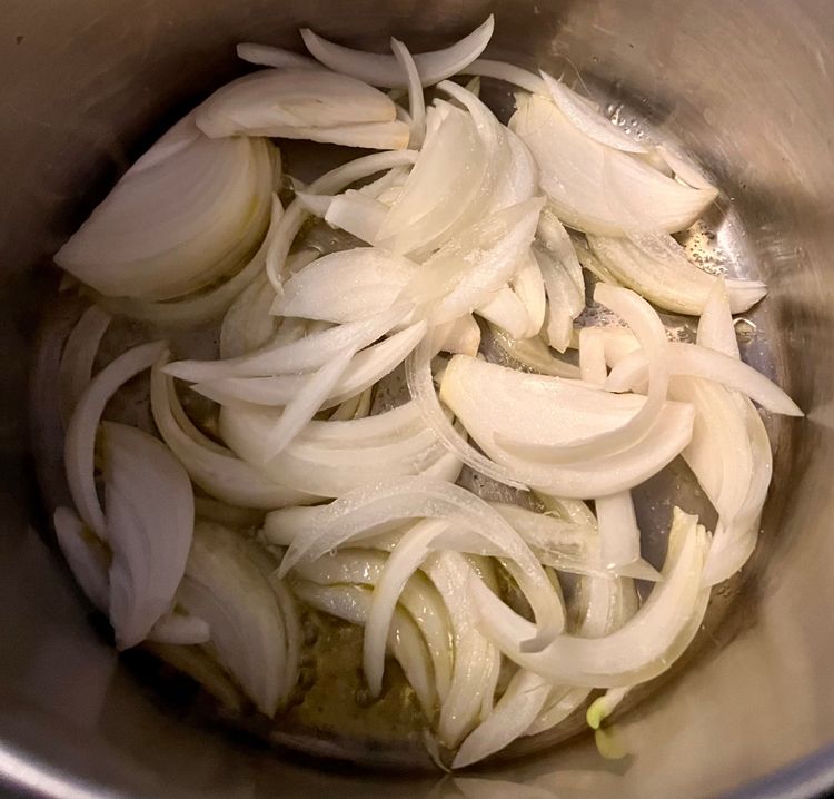 Step 2.1: Once hot enough, add the sliced onions, and sprinkle with a little kosher salt