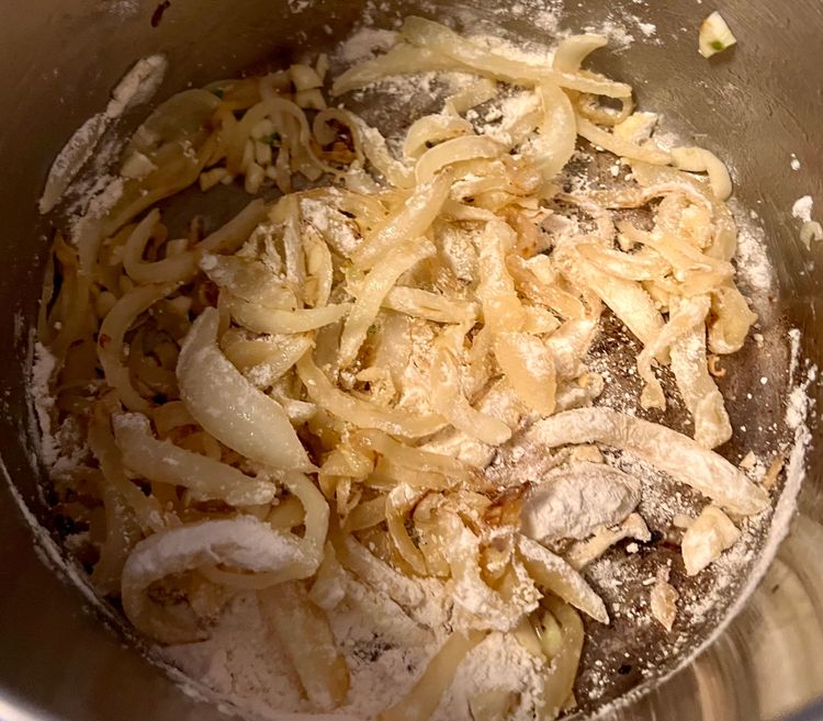 Step 2.1: Add the flour and stir immediately, just enough to mix in with the onion and garlic mixture