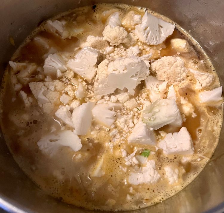 Step 2.1: Once the vegetable stock has come to a boil, add in the cauliflower