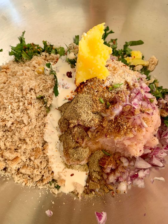 Step 1.1: In a large bowl, combine chicken mince, ginger garlic paste, chopped onions, green chillies, coriander leaves, cumin powder, red chilli flakes, garam masala, chaat masala, salt, pulsed bread slices, ghee, and fresh cream
