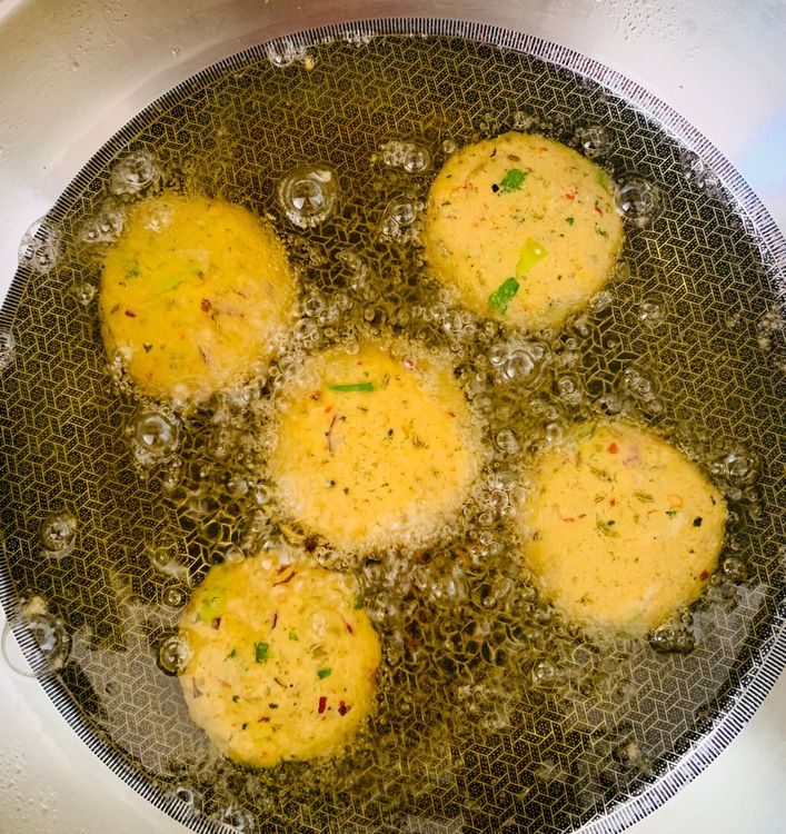 Step 1.1: Carefully slide the shaped vadai into the hot oil, allowing them to cook undisturbed for a few minutes until they firm up (2-3 minutes)