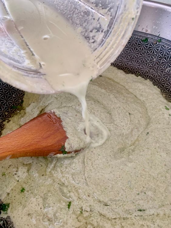 Step 5.1: Stir in the prepared onion-cashew paste with ½ cup water