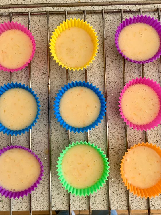 Step 5.1: Pour the batter into the prepared moulds, filling each about three-quarters full