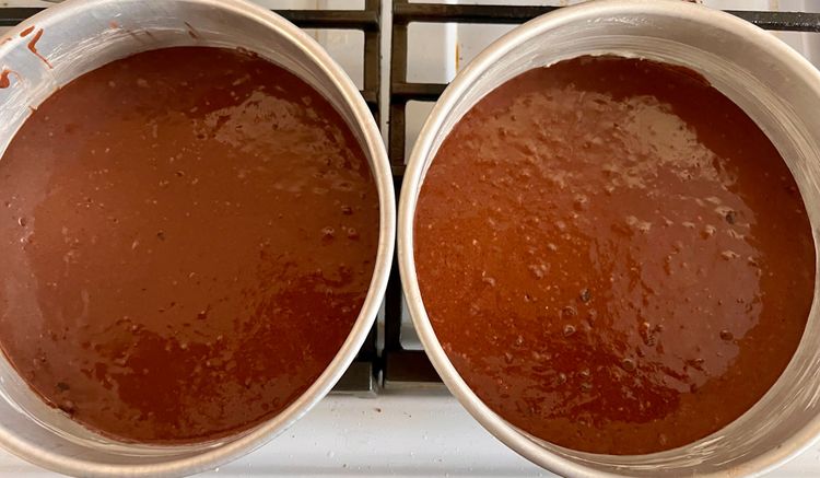 Step 1.1: Place an equal amount of batter in both prepared cake tins, smoothing the batter over with a spatula or spoon to assure it’s level